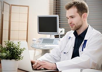 UB chiropractic student on a laptop